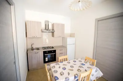 a small kitchen with a table and chairs in a kitchen at Appartamenti Duchessa in Castellammare del Golfo