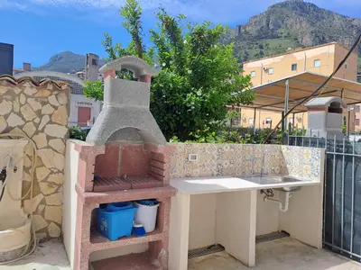 a outdoor kitchen with a stove on a balcony at Appartamenti Duchessa in Castellammare del Golfo