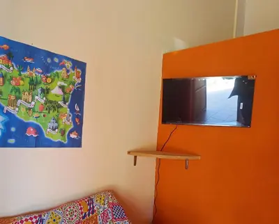 a room with a flat screen tv on the wall at Villette di Scopello - Casa Vacanze in Scopello