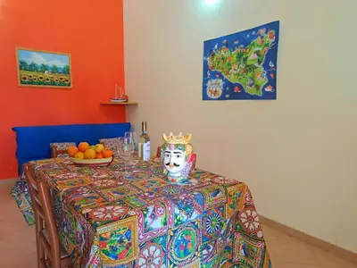 a table with a table cloth with a crown on it at Villette di Scopello - Casa Vacanze in Scopello