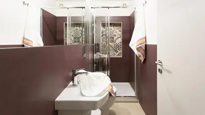 a bathroom with a toilet and a sink and a shower at SpAsimoH-1 in Palermo