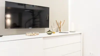 a tv sitting on top of a white dresser at SpAsimoH-1 in Palermo