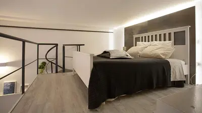 a bedroom with a bed with a black and white blanket at SpAsimoH-1 in Palermo