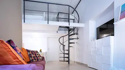 a loft bed in a room with a couch at SpAsimoH-2 in Palermo