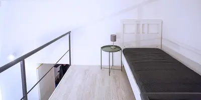 a room with a couch and a table and a staircase at SpAsimoH-2 in Palermo