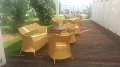 a row of chairs and tables on a porch at La Marsa Vacances in Mondello