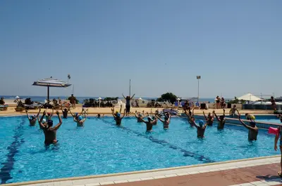 a group of people in a swimming pool at La Marsa Vacances in Mondello