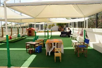 a tent with tables and chairs on a green floor at La Marsa Vacances in Mondello