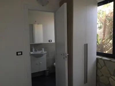 a bathroom with a sink and a mirror at Dolce Vita casa vacanze in Carini