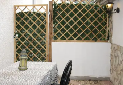 a table with a white table cloth on a table with a fence at Dolce Vita casa vacanze in Carini