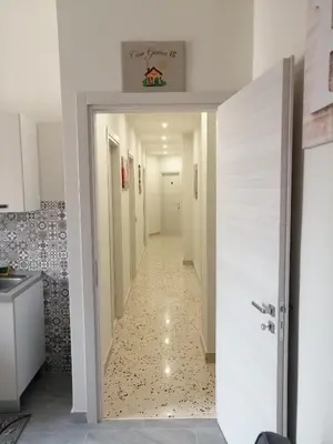 a hallway with a door leading into a room at Casagioiosa18 in Palermo