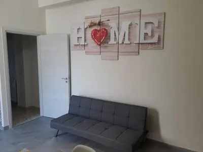 a living room with a couch and a heart on the wall at Casagioiosa18 in Palermo