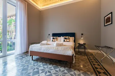 a bedroom with a bed and a large window at casa mo room and suite in Palermo