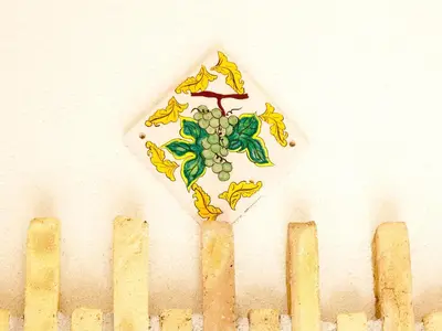 a painting of a vine on a wall next to a line at Villa in Alia with Pool & Olive Views in Alia