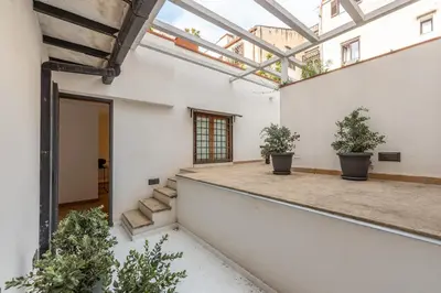 an indoor courtyard with potted plants and a glass roof at Torremuzza Homes by Wonderful Italy in Palermo