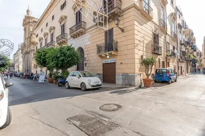 a small white car parked in front of a building at Torremuzza Homes by Wonderful Italy in Palermo