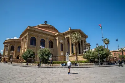 a man standing in front of a large building at A casa di Antonietta in Palermo