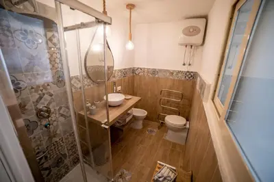 a bathroom with a shower and a sink and a toilet at A casa di Antonietta in Palermo