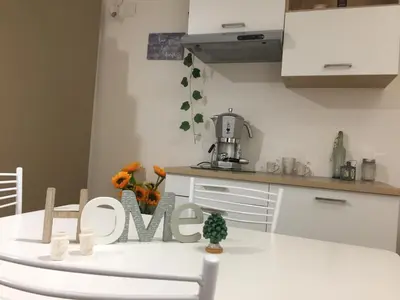 a kitchen with a table with the word love written on it at A casa di Antonietta in Palermo