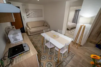 a small living room with a table and a couch at A casa di Antonietta in Palermo