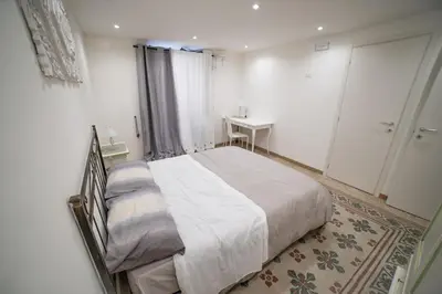 a bedroom with a bed and a table and a window at A casa di Antonietta in Palermo