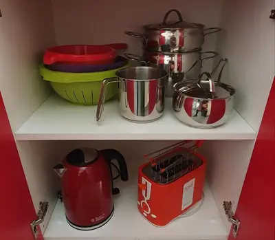a shelf with pots and pans and a tea kettle at Arco del Sole 2 in Palermo