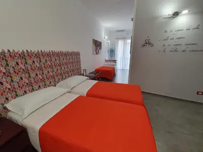 a bedroom with a bed and a wall with writing on it at Arco del Sole 2 in Palermo