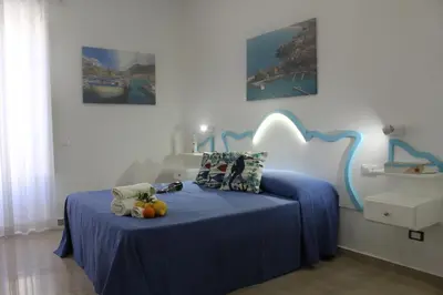 a bedroom with a blue bed with fruit on it at EXCLUSIVE HOME in Castellammare del Golfo