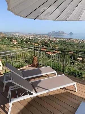a white bench sitting on a balcony with a view of the city at Villa Ibiscus in Mandra Capreria