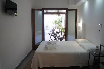 a bedroom with a bed with two towels on it at Finisterre in San Vito lo Capo