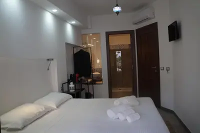 a bedroom with a bed with towels on it at Finisterre in San Vito lo Capo