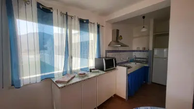 a kitchen with a sink and a microwave at Villetta SanVito - Sunrise & Sunset in San Vito lo Capo