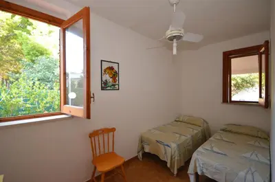 a bedroom with a bed and a window at Villetta SanVito - Sunrise & Sunset in San Vito lo Capo