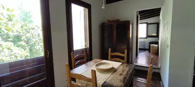 a dining room with a wooden table and a window at Palermo Holiday Studio in Palermo