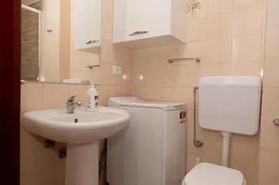 a small bathroom with a toilet and a sink at Appartamento Conturrana Sul Mare in San Vito lo Capo