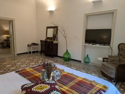 a living room with a television and a table at B&B del Parlamento in Palermo