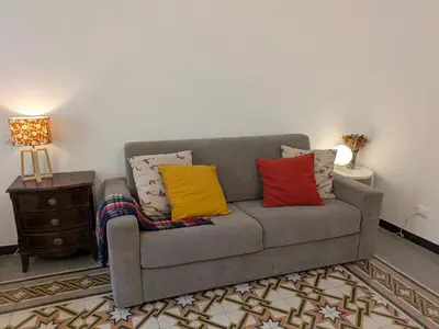a couch with colorful pillows on it in a living room at B&B del Parlamento in Palermo