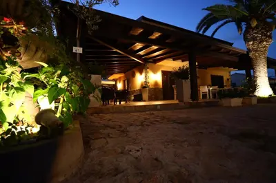a patio of a house at night at Sunrise in Lascari