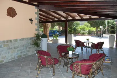 a patio with chairs and tables and a table and chairs at Sunrise in Lascari