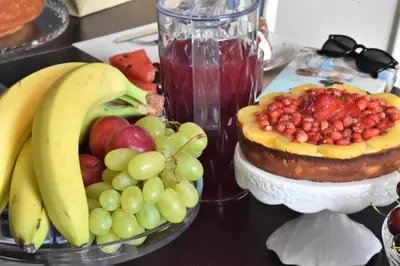 a table topped with a plate of fruit and a cake at Bed and Breakfast Il Girasole in Mondello