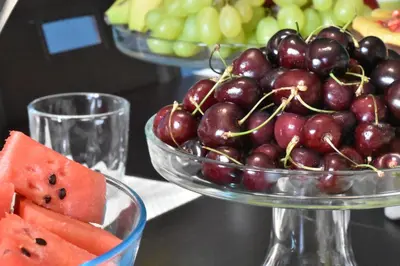 a bowl of grapes and watermelon and a bowl of fruit at Bed and Breakfast Il Girasole in Mondello