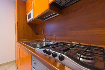 a kitchen with a stove and a sink at Palazzo Gallo in Palermo