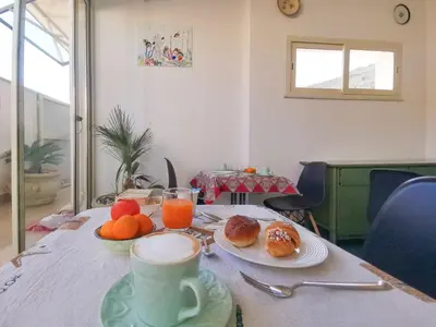 a table with a cup of coffee and plates of food at B&B Una Terrazza sul Golfo di Sferracavallo in Sferracavallo