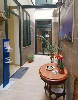 a hallway with a table in a room with plants at B&B Una Terrazza sul Golfo di Sferracavallo in Sferracavallo