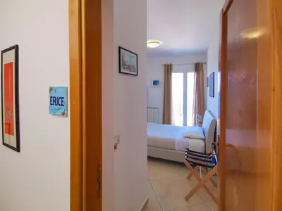 a room with a bedroom with a bed and a doorway at B&B Una Terrazza sul Golfo di Sferracavallo in Sferracavallo