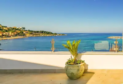 a potted plant sitting on the ledge of a window at B&B Una Terrazza sul Golfo di Sferracavallo in Sferracavallo