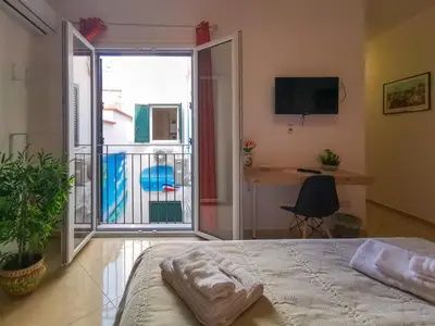 a bedroom with a bed and a view of a balcony at B&B Una Terrazza sul Golfo di Sferracavallo in Sferracavallo