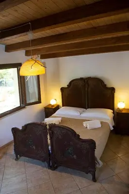 a bedroom with a large bed in a room at Villa Giardino Paradiso Cefalù con 13 posti letto e piscina riscaldata in Cefalù
