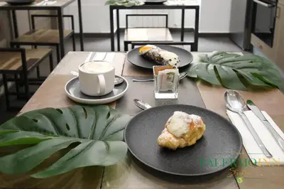 a kitchen with a table and some chairs in it at Palermo Inn Suite in Palermo