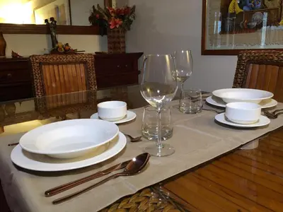 a table with plates and wine glasses on it at Armida House - Mondello in Mondello